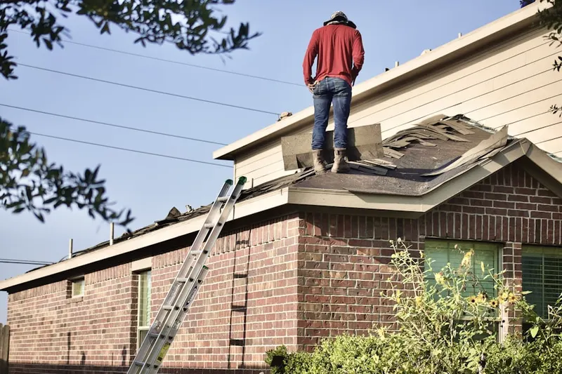 Professional roofer working on a residential roof in Herman